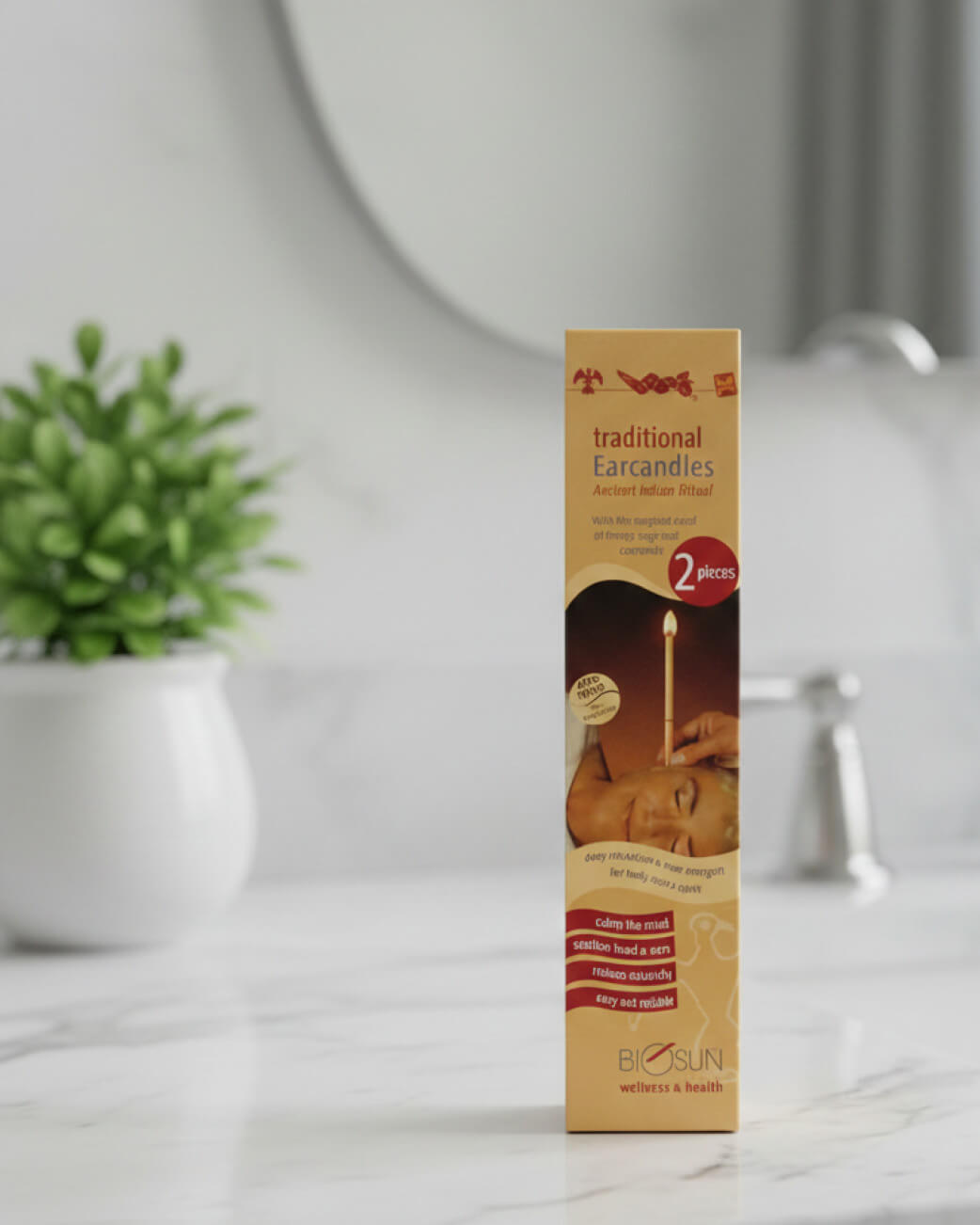 Box of BioSun traditional earcandles on a marble surface with a plant in the background