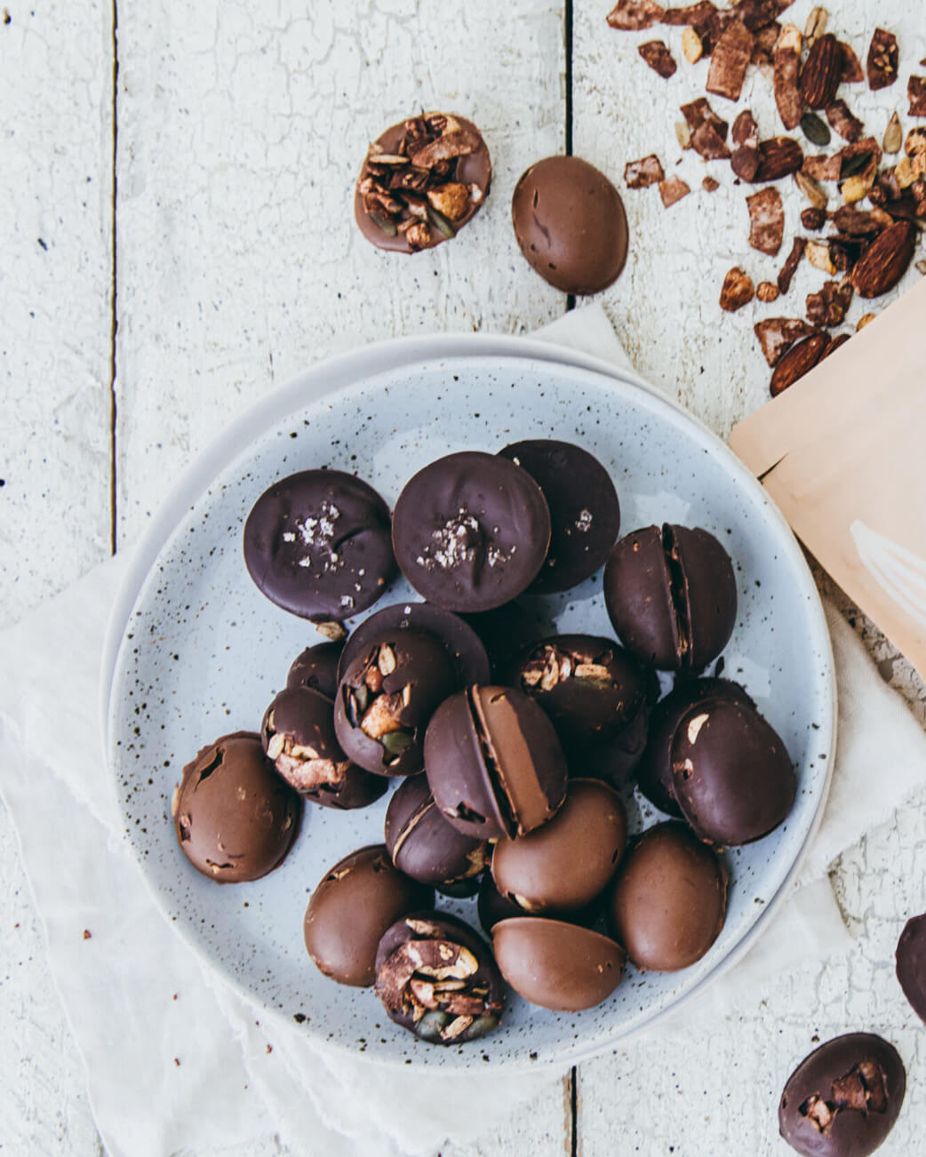 Dessert with chocolate-covered treats on a white wooden surface