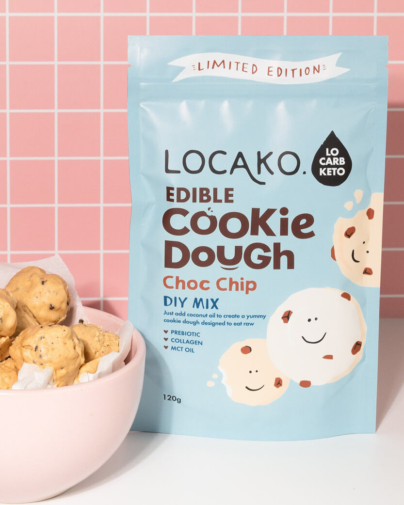 Locako edible cookie dough mix packaging with a bowl of cookie dough balls on a pink grid background.