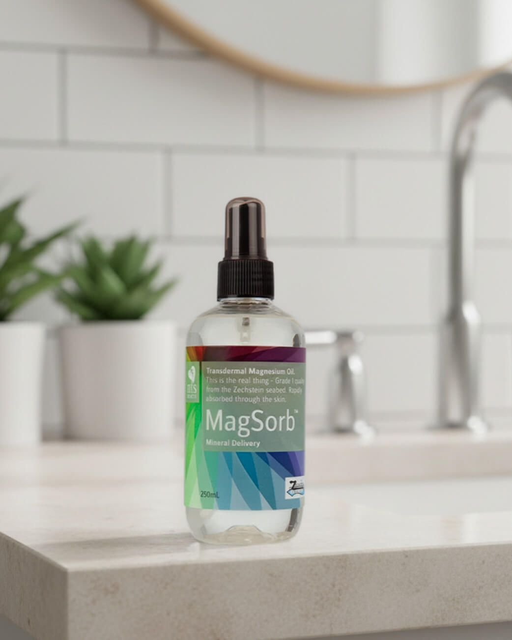 MagSorb bottle on a kitchen counter with plants and a sink in the background.