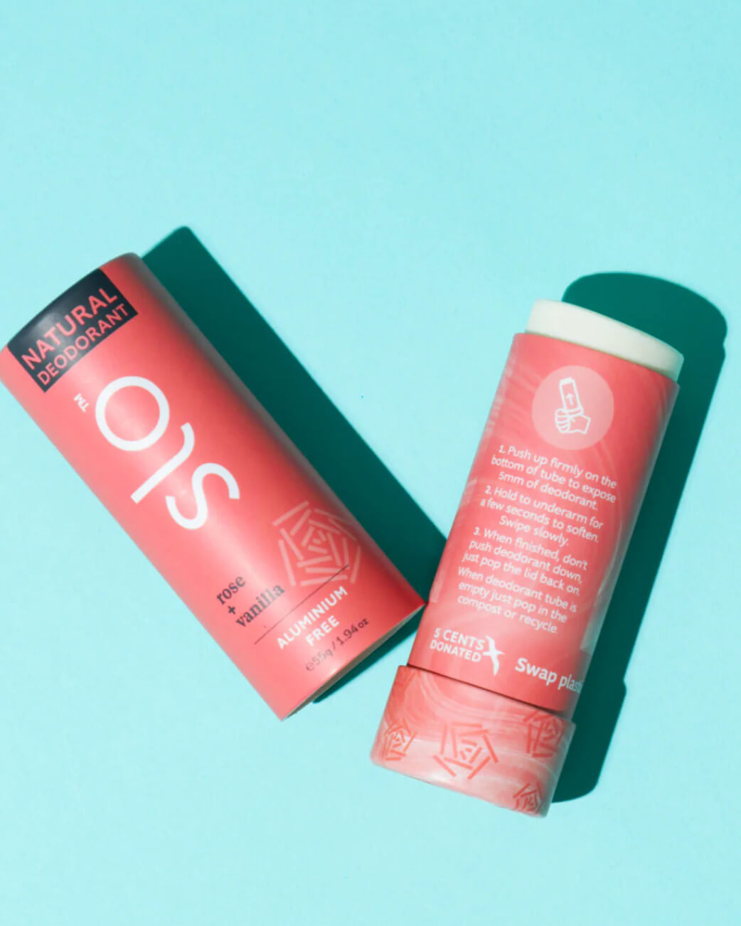 Two natural deodorant sticks on a light blue background.
