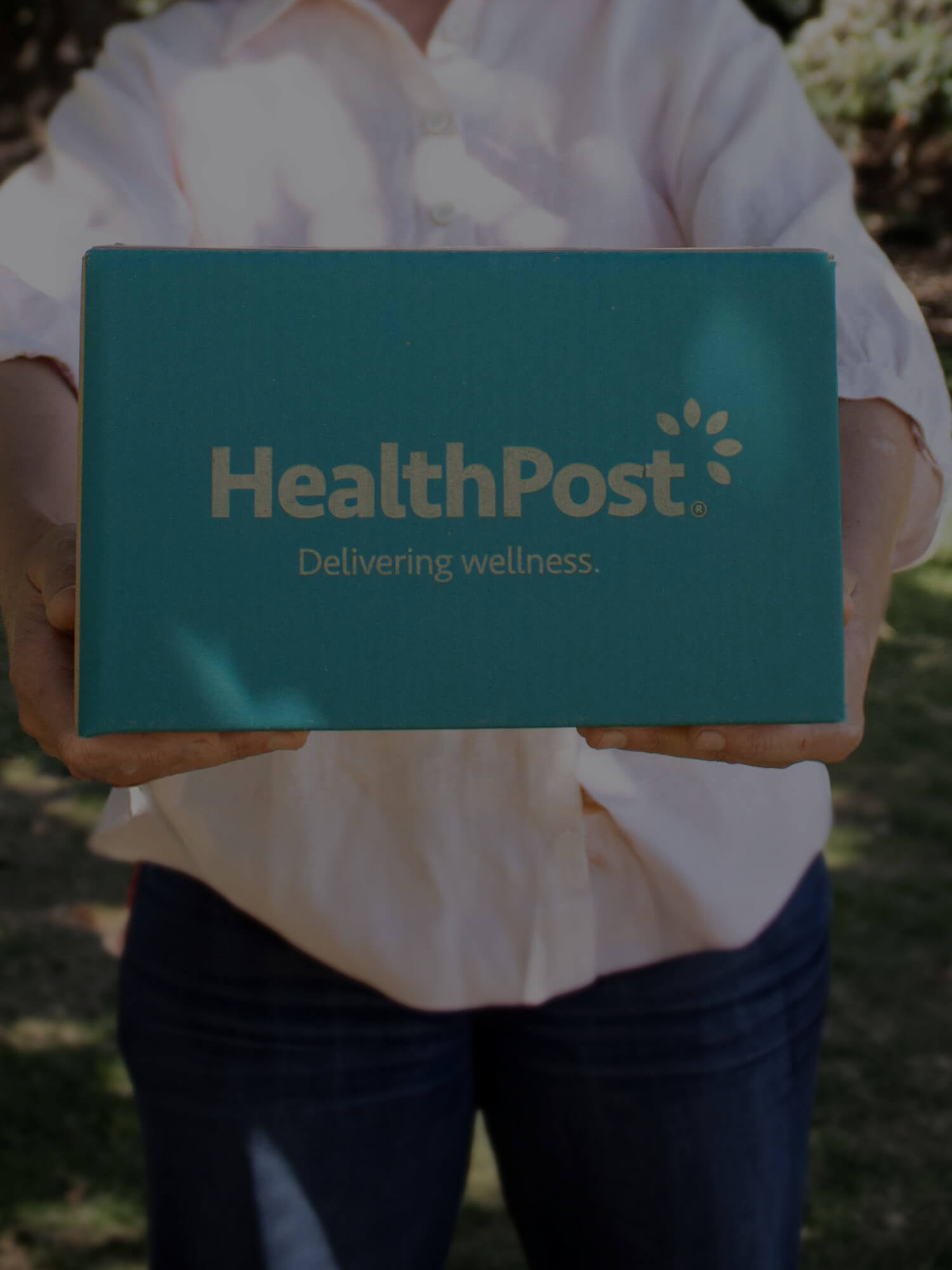 Woman holding HealthPost parcel