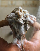 Woman washing her hair in the shower.