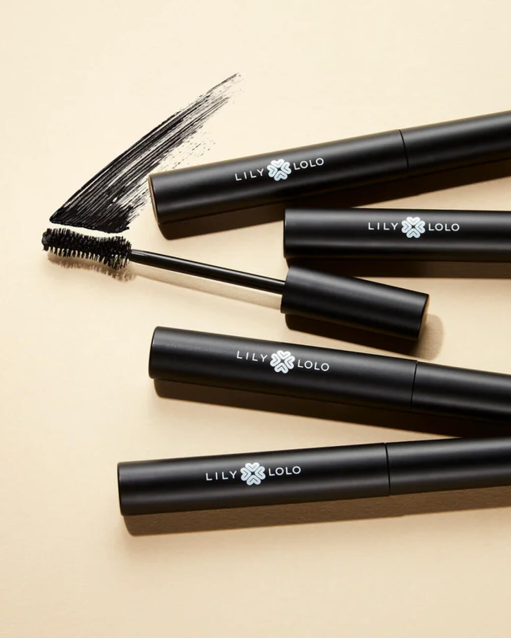 Lily Lolo mascaras against a cream background.