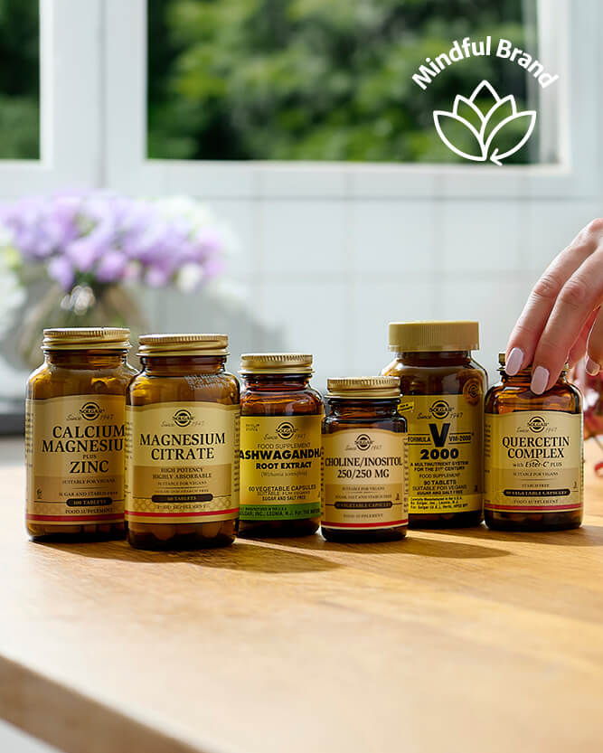Collection of supplement bottles on a wooden surface with a blurred background