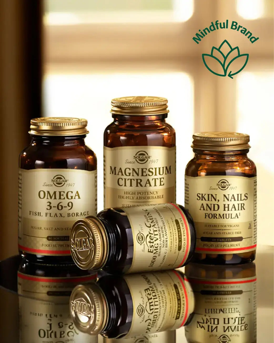 Four amber supplement bottles with gold caps and cream labels from Solgar, arranged on a reflective surface. One bottle lies on its side in front.