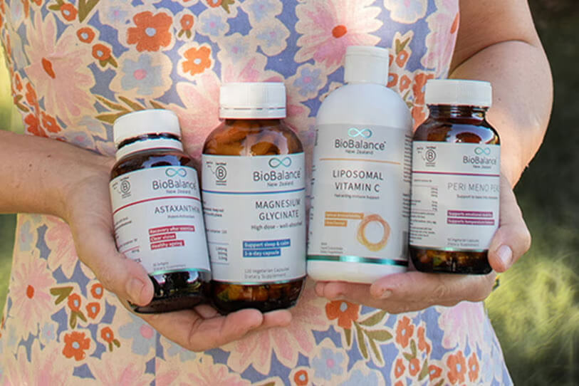 Selection of BioBalance products held in a person's hands.