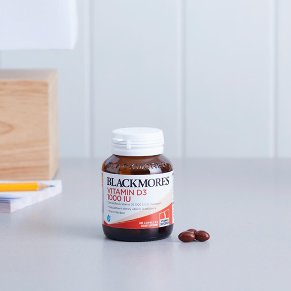 Blackmores Vitamin D3 1000IU supplement bottle on a white surface.