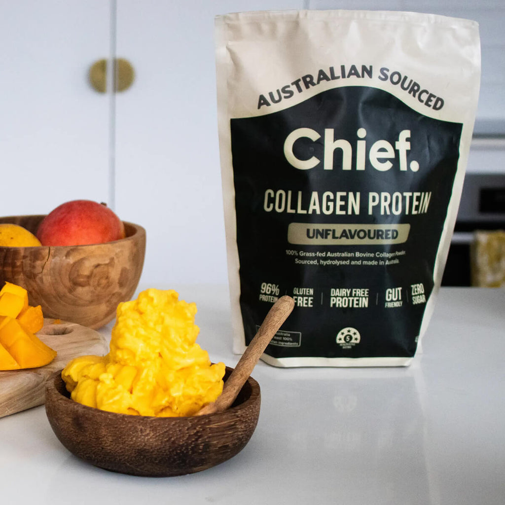 Bag of Australian Sourced Chief Collagen Protein with a bowl of fruits on a white surface.