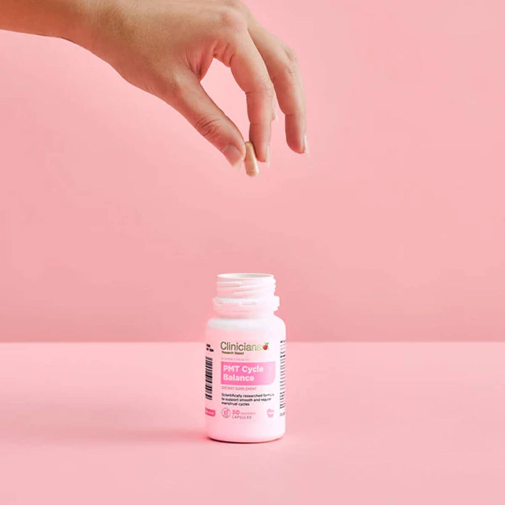 Bottle of Clinicians supplement on a pink background.