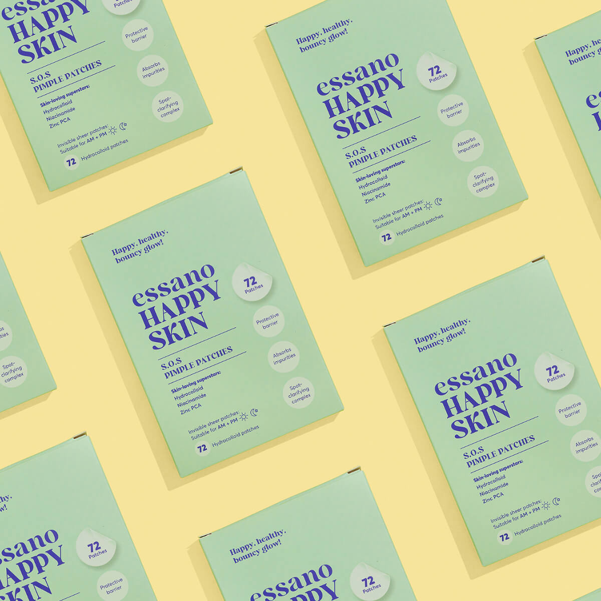 Multiple packages of essano Happy Skin on a yellow background.