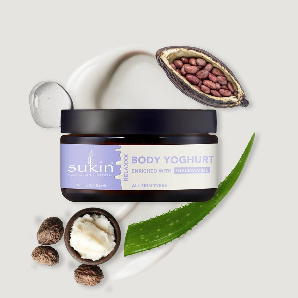 Sukin Body Yoghurt jar with ingredients on a light gray background.